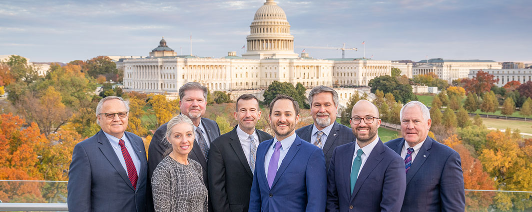 board members and government affairs team standing in front of capitol